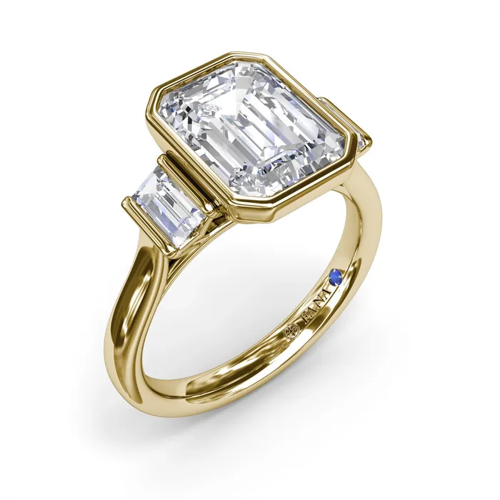 14K Yellow Gold Three Stone Bezel Set Emerald Cut Diamond Ring with Baguette Diamond Sides Fana Rings 14K Yellow Gold Three Stone Bezel Set Emerald Cut Diamond Ring with Baguette Diamond Sides Fana Rings